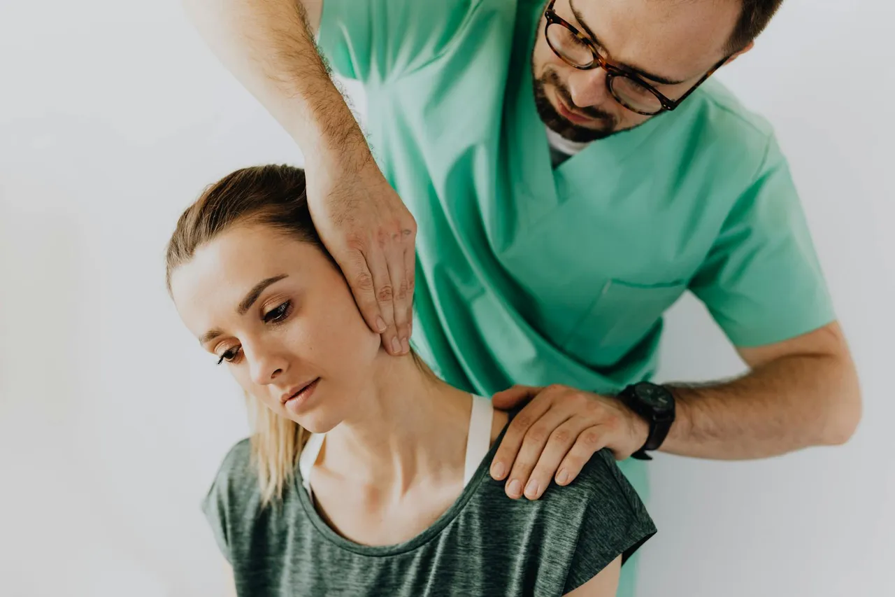 Chiropractor performing a spinal adjustment on a patient's lower back in a professional clinic setting
